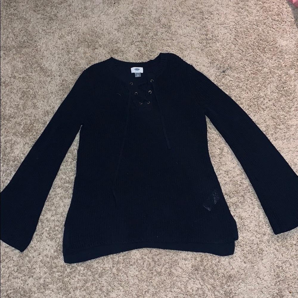 navy blue sweater with cross at top